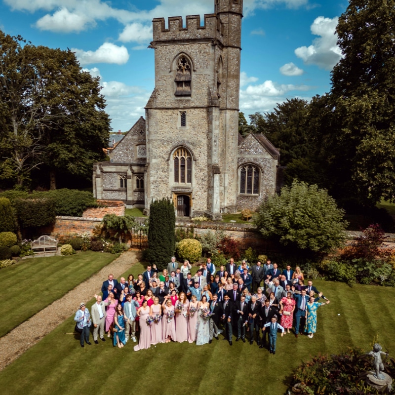 Chenies Manor House wedding party in the shadow of Chenies Church