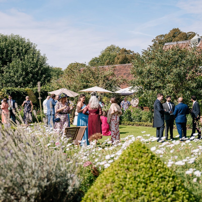 Chenies Manor House wedding reception guests on lawn