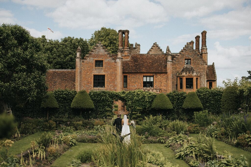 Chenies Manor House bride & groom in garden