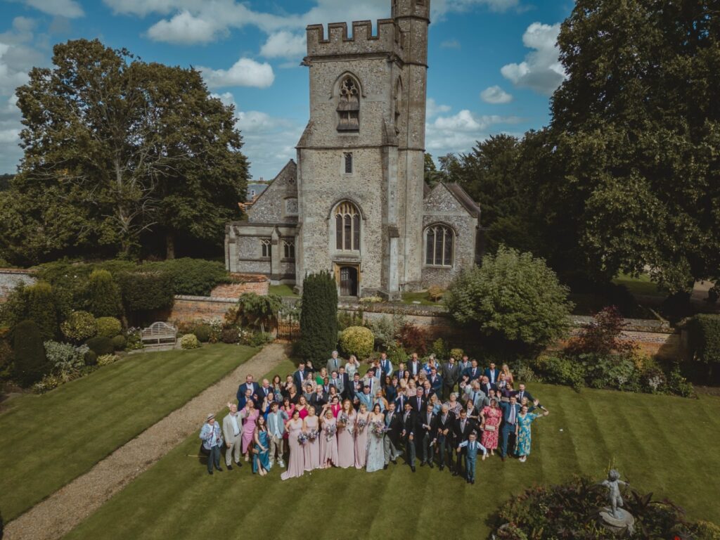 Chenies Manor House wedding party in the shadow of Chenies Church